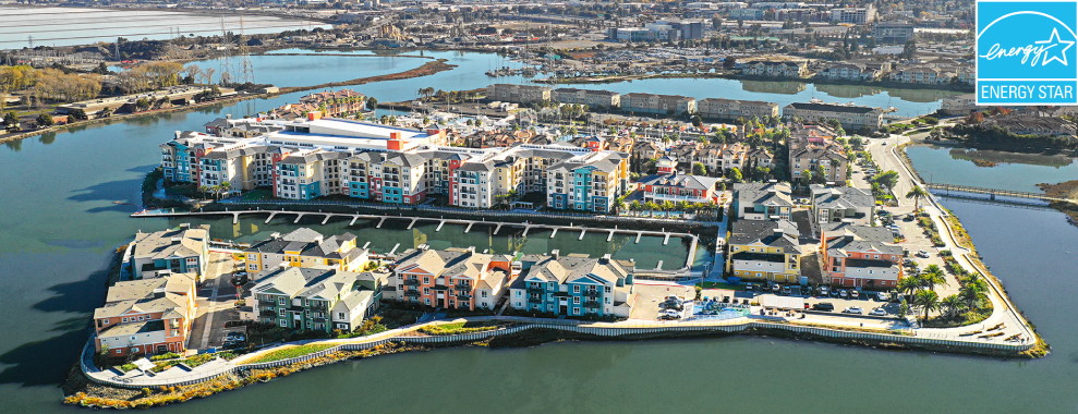 Aerial view of Blu Harbor, a large group of buildings surrounded by a body of water. Energy star award logo