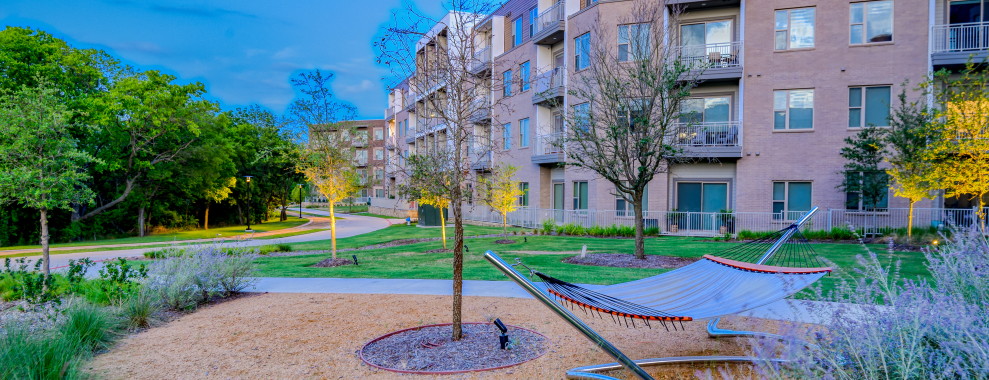 Buildings with trees and a hammock