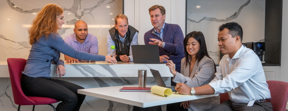 A group of people sitting at a table working together